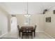 Dining room with dark wooden table and chairs and arched entry to other rooms at 2662 Haulover Blvd, Deltona, FL 32738