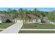 Single-story home with a well-manicured front yard and a paved driveway leading to the garage at 2662 Haulover Blvd, Deltona, FL 32738