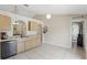Kitchen features appliances, light wood cabinets, with entry to adjacent dining area at 2662 Haulover Blvd, Deltona, FL 32738