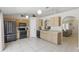 Bright kitchen features appliances, light wood cabinets, and an arched entry to other rooms at 2662 Haulover Blvd, Deltona, FL 32738