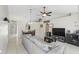 Open-concept living room featuring neutral tones, tile flooring, and ample natural light at 2662 Haulover Blvd, Deltona, FL 32738