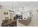 Bright living room with tiled floors, ceiling fan, and comfortable gray sectional sofa with large windows at 2662 Haulover Blvd, Deltona, FL 32738