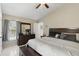 Well-lit main bedroom offering a ceiling fan, tiled floors, dresser, and window views of backyard at 2662 Haulover Blvd, Deltona, FL 32738