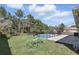 Backyard featuring an in-ground pool, a fenced-in pool area, and a spacious lawn perfect for recreation at 2662 Haulover Blvd, Deltona, FL 32738