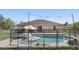 Backyard pool area showcasing in-ground pool, patio, lounge chair, and fully fenced yard at 2662 Haulover Blvd, Deltona, FL 32738