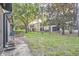 Spacious backyard with lush grass, mature trees, and screened patios with backyard views at 2804 Polvadero Ln # 107, Orlando, FL 32835