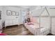 Charming bedroom with a custom built-in bed, natural light, and modern wood floors at 2804 Polvadero Ln # 107, Orlando, FL 32835