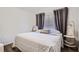 Bedroom featuring a decorative bed, hardwood floors, a window with curtain, and a side table at 2804 Polvadero Ln # 107, Orlando, FL 32835