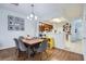 Dining area with a wood table, gray chairs, and hardwood floors adjacent to the kitchen at 2804 Polvadero Ln # 107, Orlando, FL 32835
