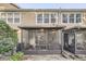 Back of home view featuring a screened patio, with an open yard and neighboring properties at 2804 Polvadero Ln # 107, Orlando, FL 32835