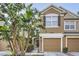 Inviting two-story townhome with a single-car garage and lush tropical landscaping at 2804 Polvadero Ln # 107, Orlando, FL 32835