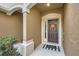 Covered front porch with a decorative wreath and a 'hello' welcome mat at 2804 Polvadero Ln # 107, Orlando, FL 32835
