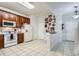Bright kitchen with tile flooring, wood cabinets, white appliances, and retro Coca-Cola themed decor at 2804 Polvadero Ln # 107, Orlando, FL 32835