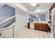 Spacious kitchen with tile flooring, wood cabinets, and a view to the living area and stairs at 2804 Polvadero Ln # 107, Orlando, FL 32835