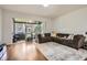 Spacious living area with hardwood floors, a large sectional sofa, and a sliding glass door to the patio at 2804 Polvadero Ln # 107, Orlando, FL 32835