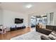 Open living room with hardwood floors, a sliding glass door, and a comfortable sofa at 2804 Polvadero Ln # 107, Orlando, FL 32835
