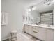 Main bathroom showcases a dual sink vanity, large mirror, tiled floors, and shower-tub combo at 2804 Polvadero Ln # 107, Orlando, FL 32835