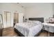Main bedroom shows wood-look flooring, a modern bed and furnishings, and view to the ensuite at 2804 Polvadero Ln # 107, Orlando, FL 32835