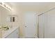 Bathroom featuring double sinks, neutral walls, and a glass shower at 2871 Parkfield Rd, St Cloud, FL 34772