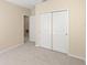 Bedroom with a closet and doorway to another room with carpet flooring at 2871 Parkfield Rd, St Cloud, FL 34772