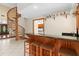 Cozy bar area with a beautiful wooden spiral staircase and clear view into the kitchen at 2931 Sunbittern Ct, Windermere, FL 34786