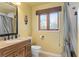 Traditional bathroom featuring a wood vanity with granite countertop and a shower with patterned curtain at 2931 Sunbittern Ct, Windermere, FL 34786