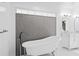 Luxurious bathroom featuring a standalone tub, modern fixtures and a decorative tile accent wall at 2931 Sunbittern Ct, Windermere, FL 34786