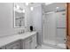 Modern bathroom with a glass-enclosed shower, updated vanity, and stylish lighting fixtures at 2931 Sunbittern Ct, Windermere, FL 34786