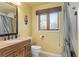 Full yellow bathroom featuring a decorative framed window and combination shower with curtain at 2931 Sunbittern Ct, Windermere, FL 34786