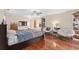 Sunlit bedroom featuring hardwood floors, lounge chairs, and lots of shelving at 2931 Sunbittern Ct, Windermere, FL 34786