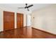 Bedroom featuring hardwood floors, a ceiling fan, and closet doors at 2931 Sunbittern Ct, Windermere, FL 34786