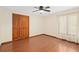 Bedroom featuring hardwood floors, a ceiling fan, closet, and a large window at 2931 Sunbittern Ct, Windermere, FL 34786