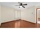 Bedroom featuring hardwood floors, a ceiling fan, closet, and a large window at 2931 Sunbittern Ct, Windermere, FL 34786