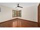 Cozy bedroom with hardwood floors, a ceiling fan, and corner windows at 2931 Sunbittern Ct, Windermere, FL 34786