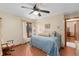 Comfortable bedroom with hardwood floors, large window and ceiling fan at 2931 Sunbittern Ct, Windermere, FL 34786