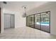 Dining room with tile floors and sliding glass doors leading to a screened patio and pool area at 2931 Sunbittern Ct, Windermere, FL 34786