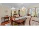 Formal dining room with a chandelier, hardwood floors, and natural light from windows creating a sophisticated ambiance at 2931 Sunbittern Ct, Windermere, FL 34786