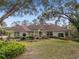 Inviting single-Gathering home with well-maintained landscaping, a spacious front lawn, and mature shady trees at 2931 Sunbittern Ct, Windermere, FL 34786
