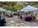 Bustling farmers market with various vendor tents and shoppers, creating a vibrant community atmosphere at 2931 Sunbittern Ct, Windermere, FL 34786