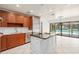 Spacious kitchen featuring stainless steel appliances, a large island and an open view of the pool at 2931 Sunbittern Ct, Windermere, FL 34786