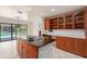 Open kitchen featuring wood cabinets, a large island, and plenty of natural light with a view of the backyard pool at 2931 Sunbittern Ct, Windermere, FL 34786
