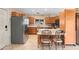 Well-lit kitchen with wooden cabinetry, stainless steel appliances, and breakfast bar at 2931 Sunbittern Ct, Windermere, FL 34786