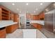Well-lit kitchen featuring a large island, stainless steel appliances and wood cabinets at 2931 Sunbittern Ct, Windermere, FL 34786
