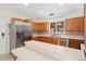 Bright kitchen with stainless steel appliances, island, and oak cabinets at 2931 Sunbittern Ct, Windermere, FL 34786