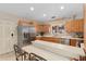 Eat-in kitchen features stainless steel appliances, wood cabinets, and breakfast bar at 2931 Sunbittern Ct, Windermere, FL 34786