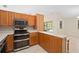 Updated kitchen featuring stainless steel appliances, breakfast bar, and natural light at 2931 Sunbittern Ct, Windermere, FL 34786