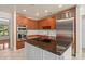 Bright kitchen featuring a large island with granite countertop, stainless steel appliances and wood cabinets at 2931 Sunbittern Ct, Windermere, FL 34786