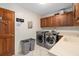 Well-equipped laundry room with modern appliances, ample counter space, and storage cabinets at 2931 Sunbittern Ct, Windermere, FL 34786