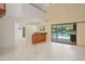 Open-concept living room featuring a wet bar and access to the pool area at 2931 Sunbittern Ct, Windermere, FL 34786
