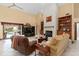 Spacious living room with a brick fireplace, built-in bookshelves, and large windows offering natural light and views at 2931 Sunbittern Ct, Windermere, FL 34786